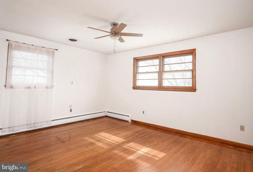 8007 Sagramore Road Baltimore, MD 21237 - Photo 20 of 41 wooden floor in an empty room with a window