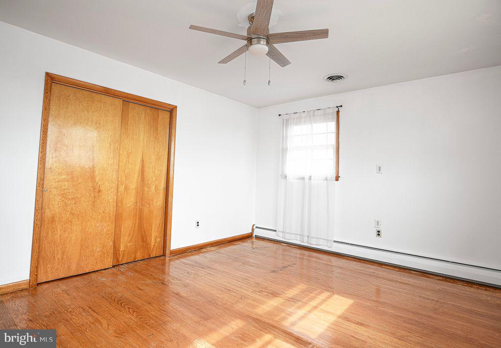 8007 Sagramore Road Baltimore, MD 21237 - Photo 21 of 41 an empty room with window and ceiling fan
