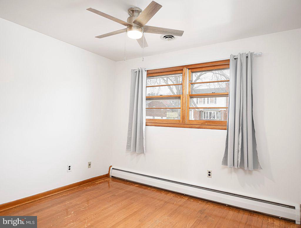 8007 Sagramore Road Baltimore, MD 21237 - Photo 22 of 41 an empty room with a window and a fan