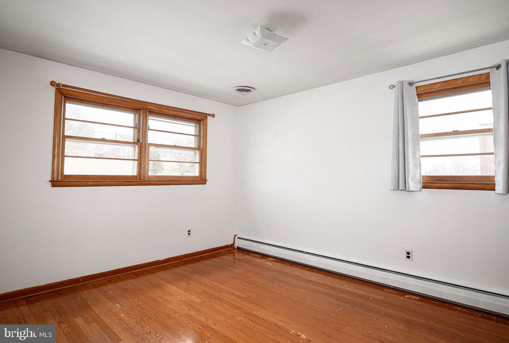 8007 Sagramore Road Baltimore, MD 21237 - Photo 24 of 41 a view of an empty room with wooden floor and a window