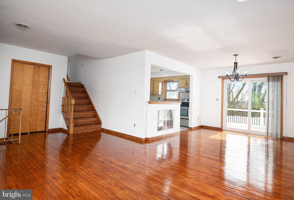 8007 Sagramore Road Baltimore, MD 21237 - Photo 7 of 41 a view of an empty room with wooden floor and a window