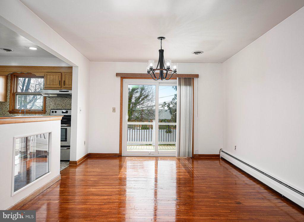 8007 Sagramore Road Baltimore, MD 21237 - Photo 9 of 41 a view of a room with wooden floor fireplace and windows