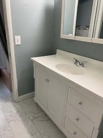 a bathroom with a sink and a mirror