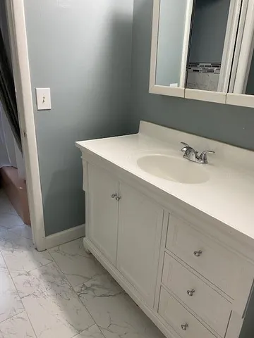 a bathroom with a sink and a mirror