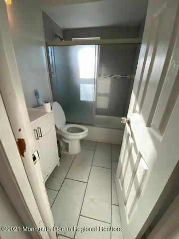 a white toilet sitting next to a window