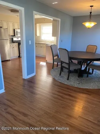 a view of a dining room with furniture and a chandelier