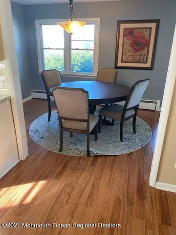a view of a dining room with furniture and window