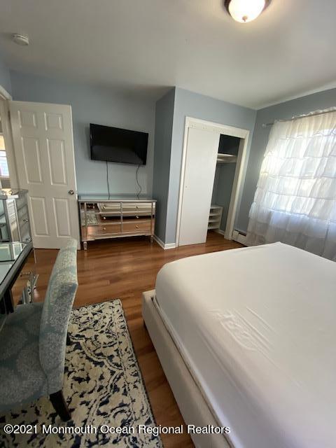 9 Howland Avenue Long Branch, NJ 07740 - Photo 9 of 18 a bedroom with a bed and a couch