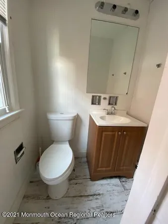 a white toilet sitting next to a bathroom sink
