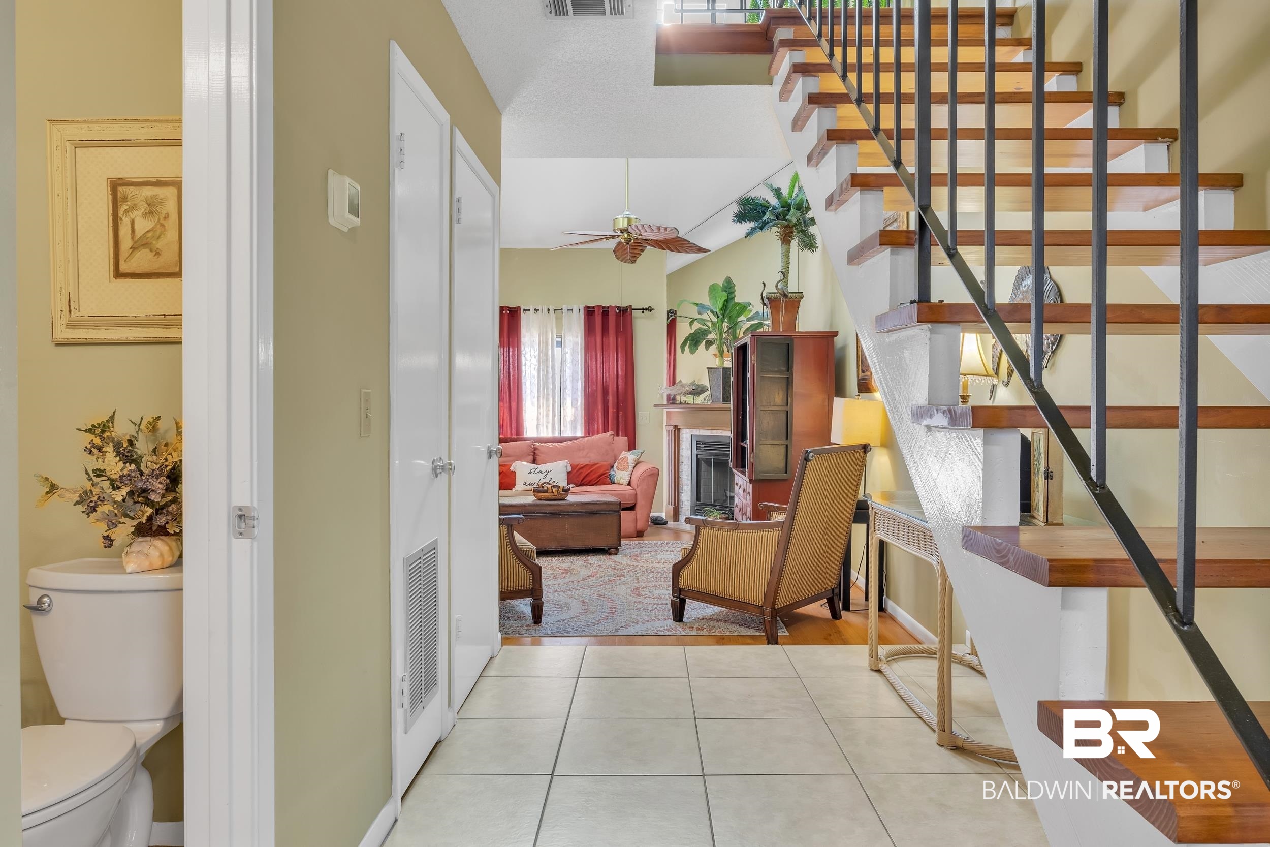 3256 Loop Road, Unit 2 Orange Beach, AL 36561 - Photo 8 of 25 Hardwood staircase with wrought iron balusters