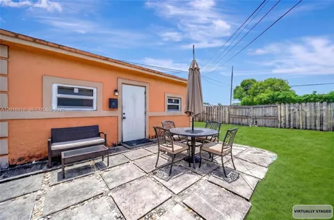 a view of a chairs and table in a backyard