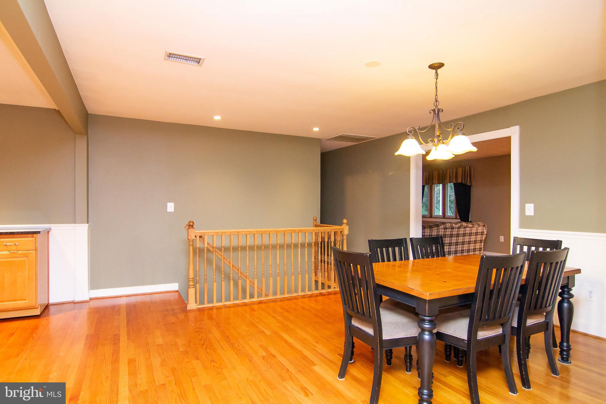 563 Oak Tree Road Westminster, MD 21157 - Photo 11 of 41 a view of a dining room with furniture and a chandelier
