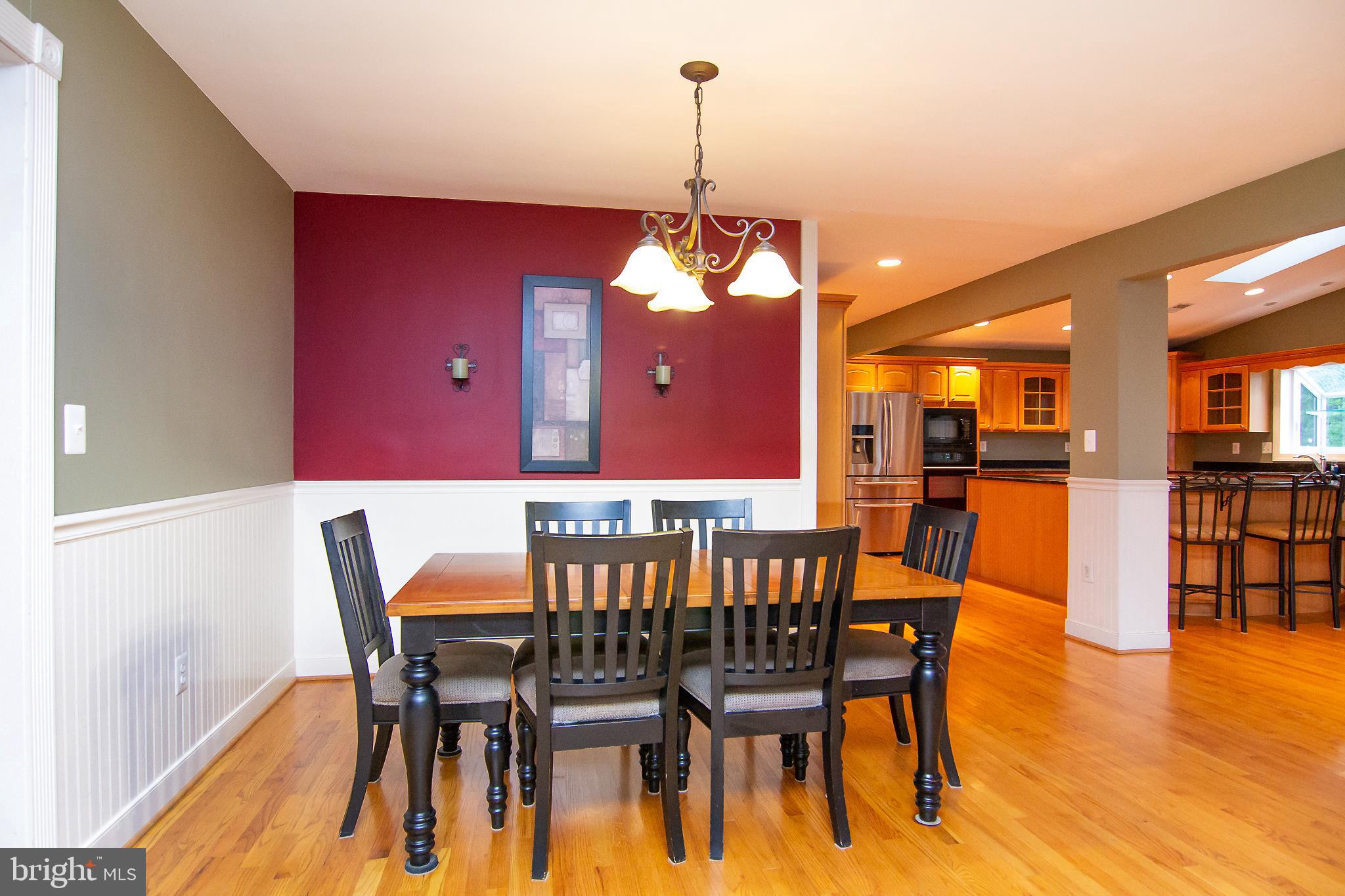 563 Oak Tree Road Westminster, MD 21157 - Photo 12 of 41 a view of a dining room with furniture and wooden floor