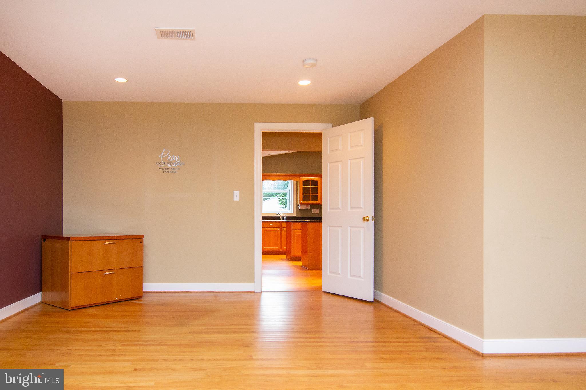 563 Oak Tree Road Westminster, MD 21157 - Photo 15 of 41 a view of an empty room with wooden floor and a window