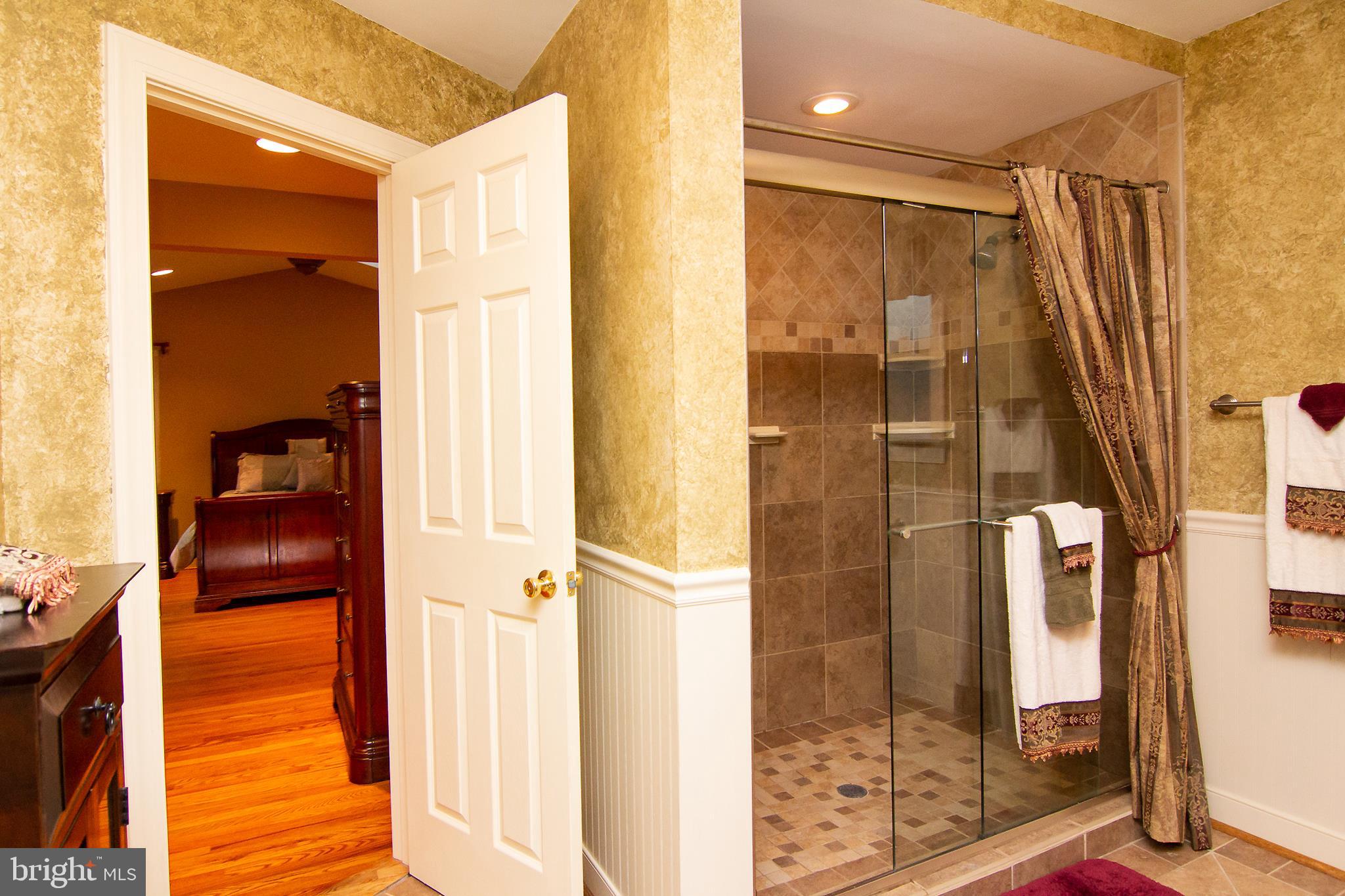 563 Oak Tree Road Westminster, MD 21157 - Photo 22 of 41 a bathroom with a shower and a glass door