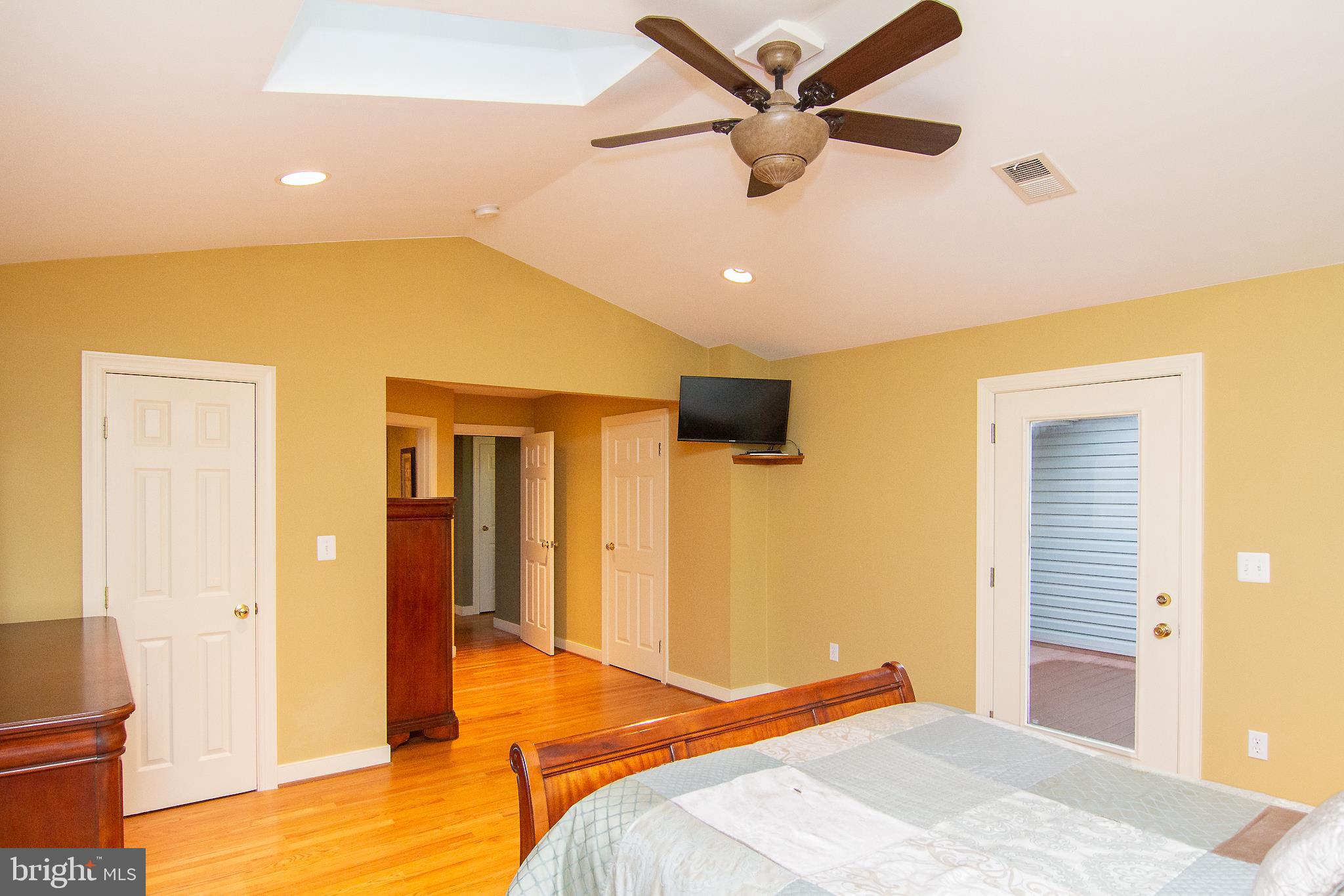 563 Oak Tree Road Westminster, MD 21157 - Photo 25 of 41 a bedroom with a bed and a chandelier