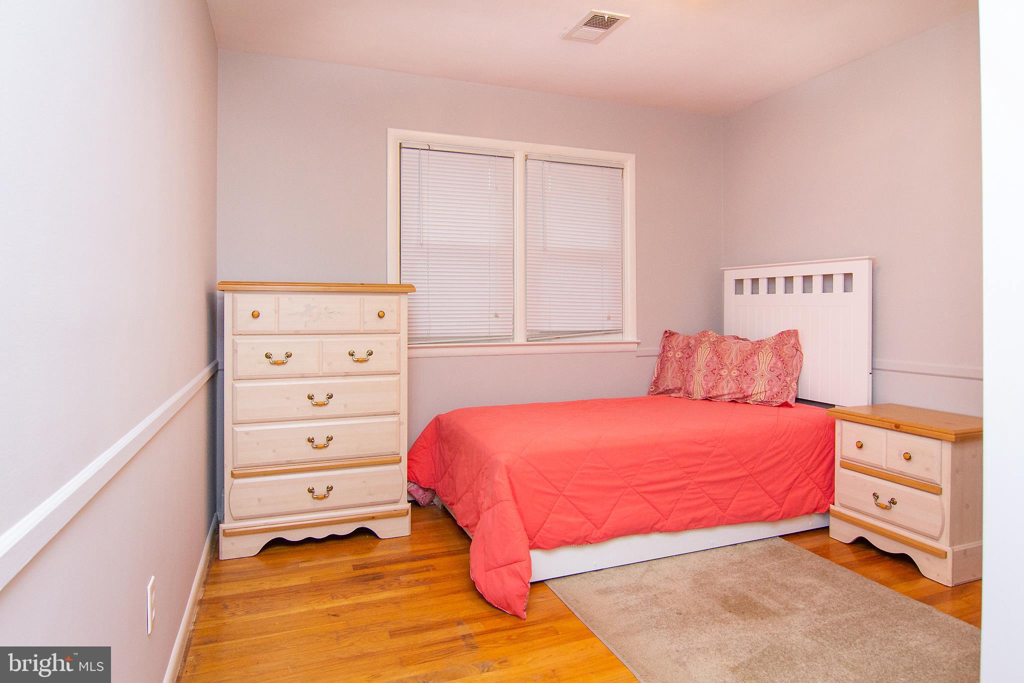 563 Oak Tree Road Westminster, MD 21157 - Photo 27 of 41 a bedroom with a bed and a night stand