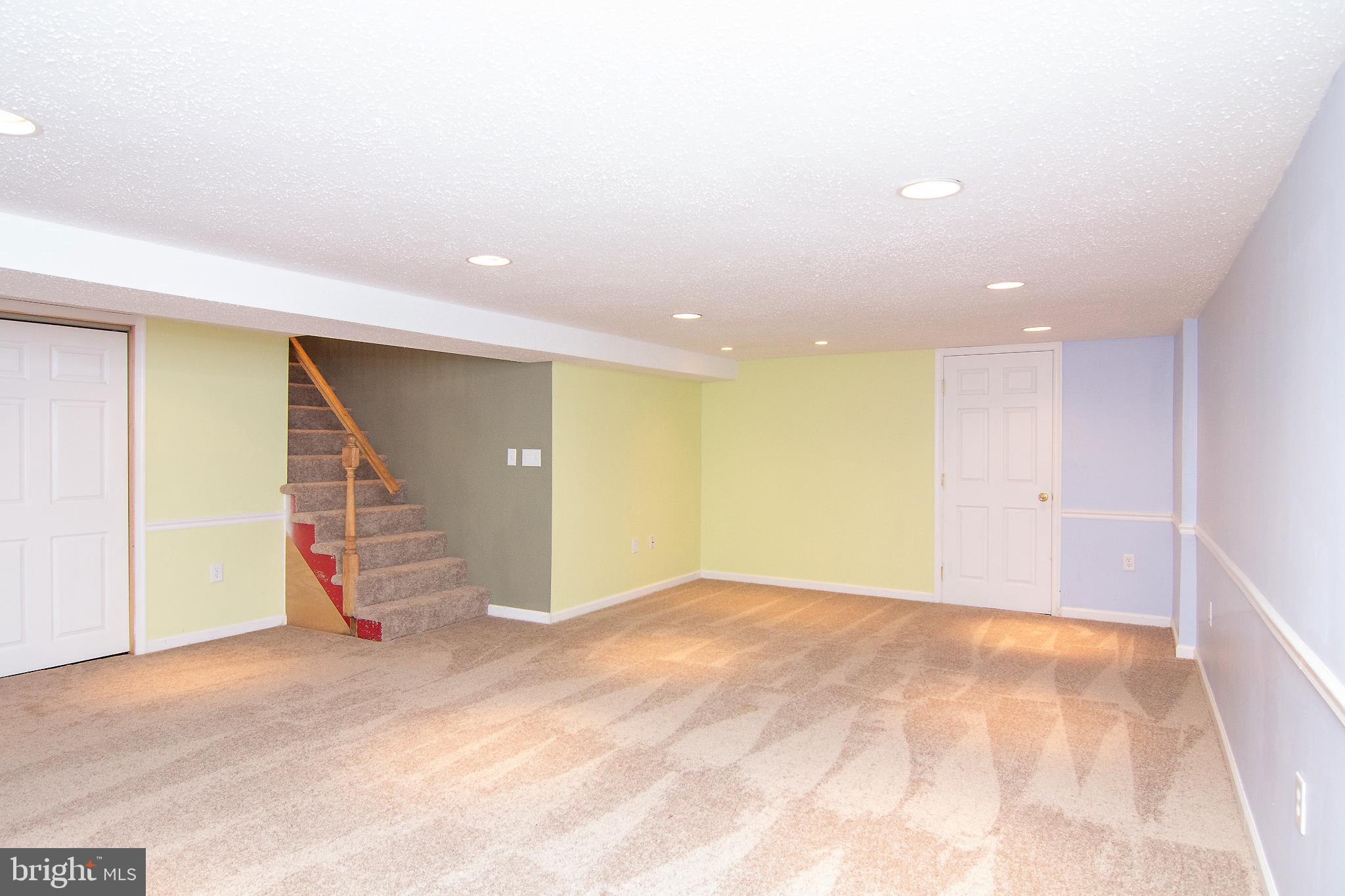 563 Oak Tree Road Westminster, MD 21157 - Photo 29 of 41 a view of an empty room with wooden floor and stairs