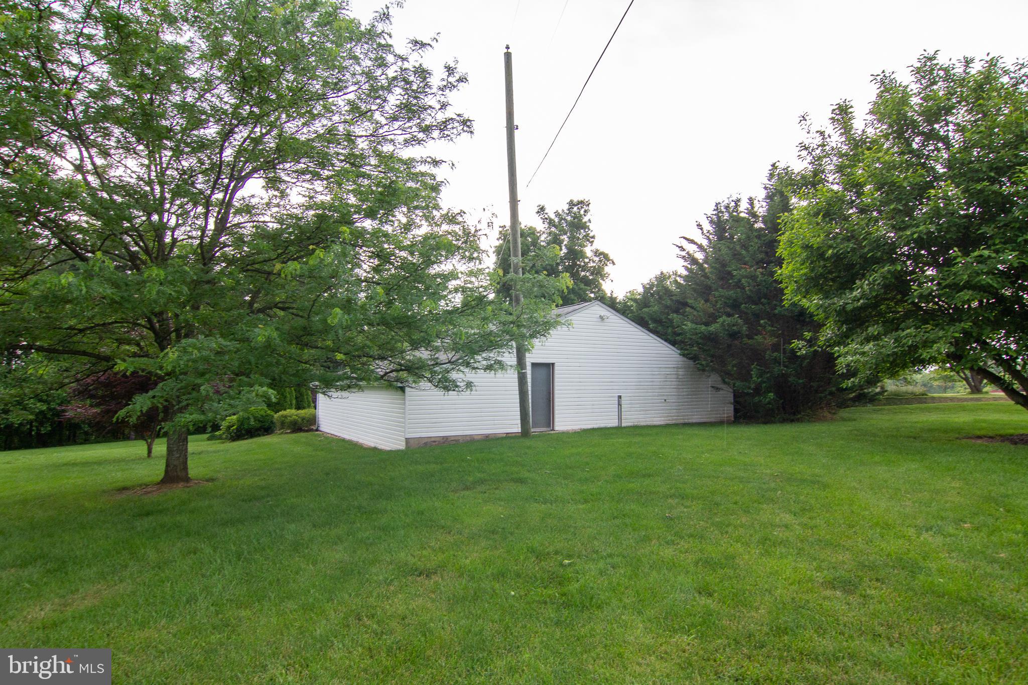 563 Oak Tree Road Westminster, MD 21157 - Photo 35 of 41 a white house that has a tree in front of it
