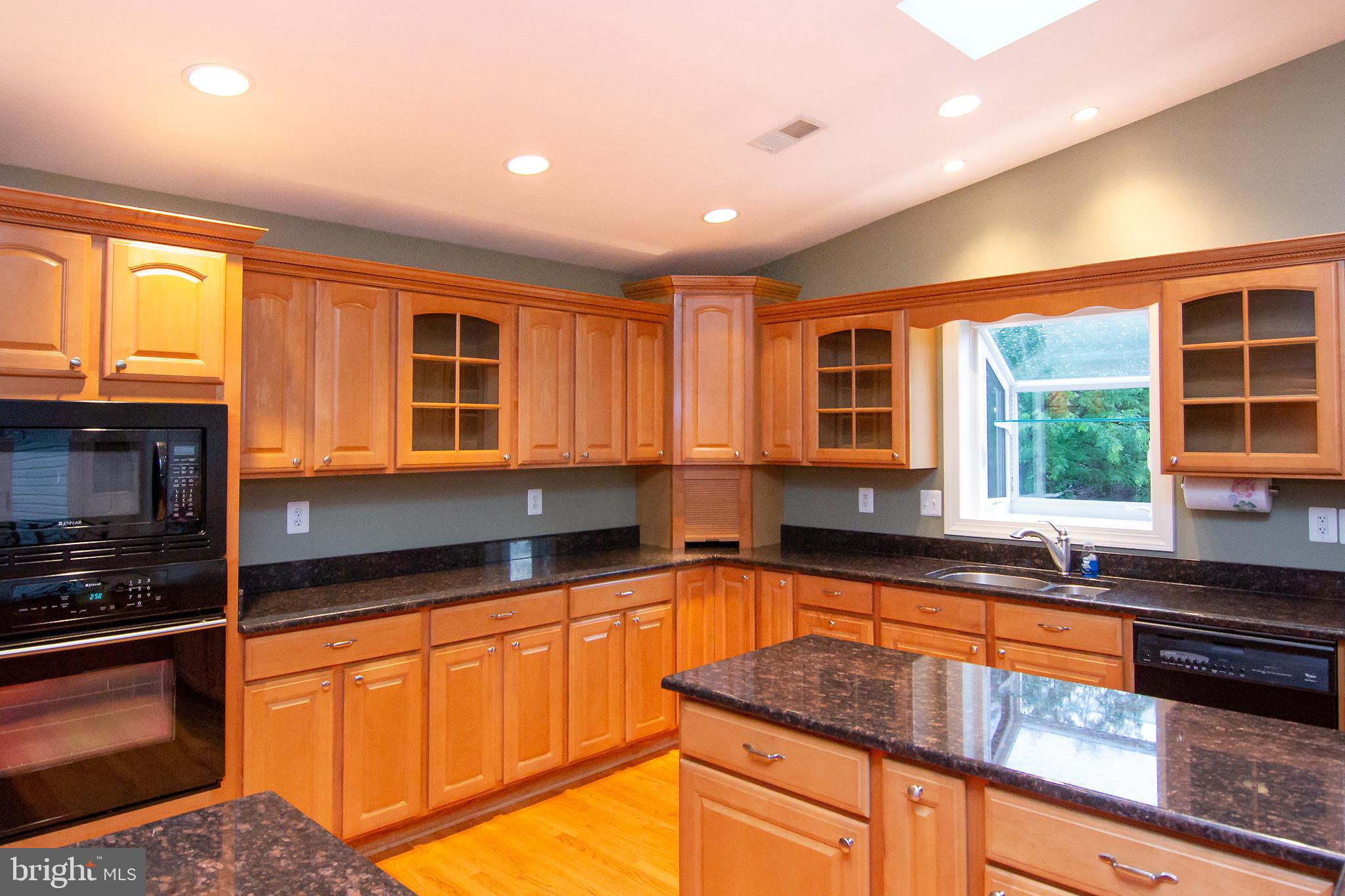 563 Oak Tree Road Westminster, MD 21157 - Photo 5 of 41 a kitchen with stainless steel appliances granite countertop a stove a sink and a granite counter tops with wooden floors