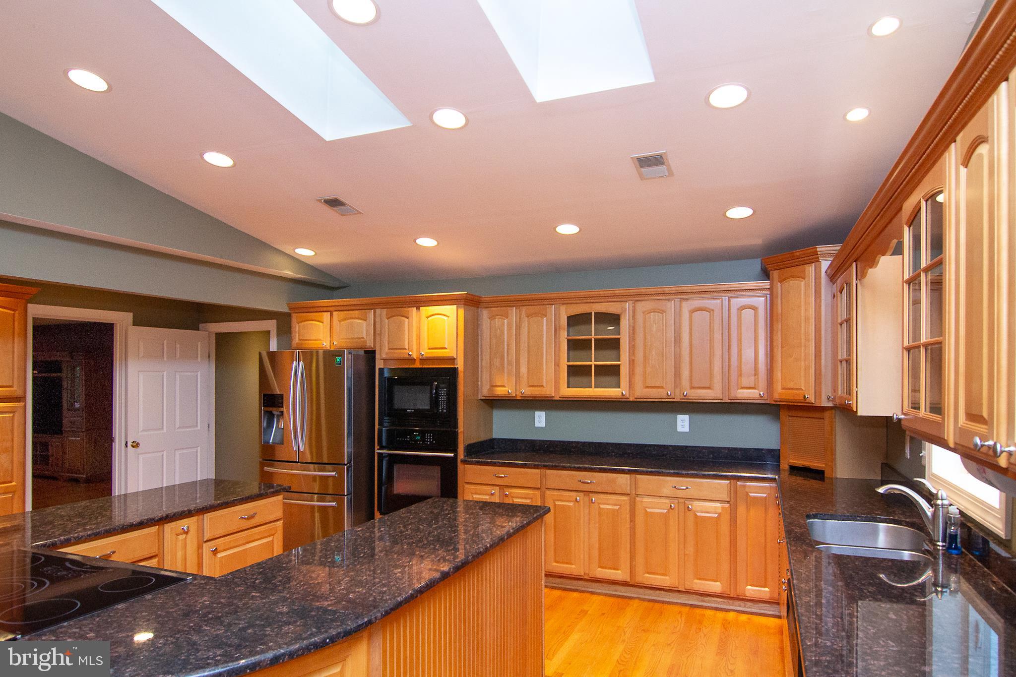 563 Oak Tree Road Westminster, MD 21157 - Photo 6 of 41 a view of a kitchen with stainless steel appliances granite countertop a large window