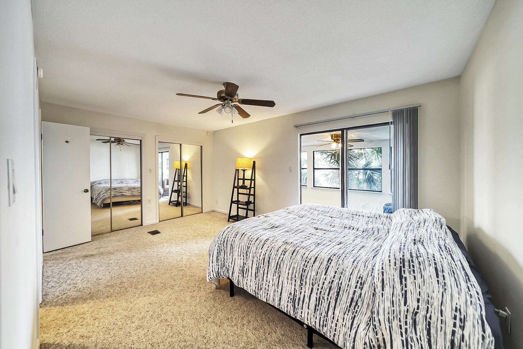 126 Walton Way, Unit 10 Miramar Beach, FL 32550 - Photo 16 of 28 a spacious bedroom with a large bed and a chandelier