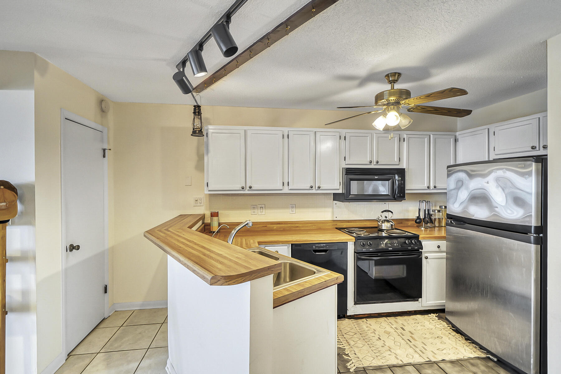 126 Walton Way, Unit 10 Miramar Beach, FL 32550 - Photo 9 of 28 a kitchen with a refrigerator sink and cabinets