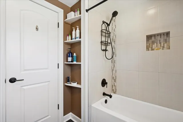 a bathroom with a bathtub and shower