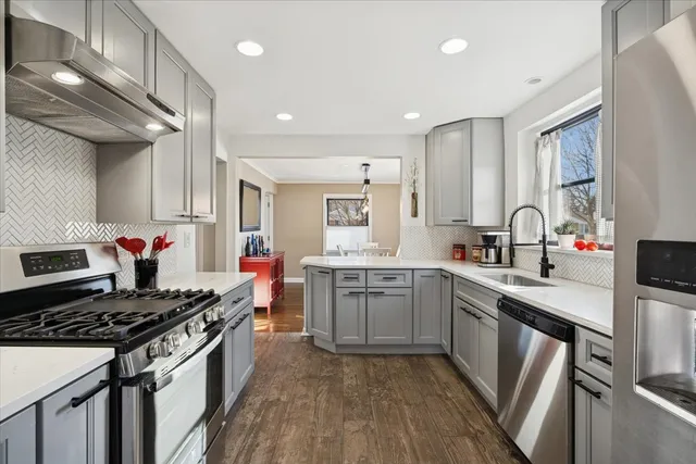 a kitchen with a sink appliances and cabinets