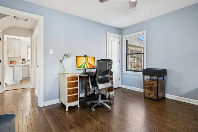 a view of a workspace with furniture and wooden floor