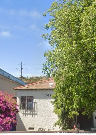 a view of a house with a tree