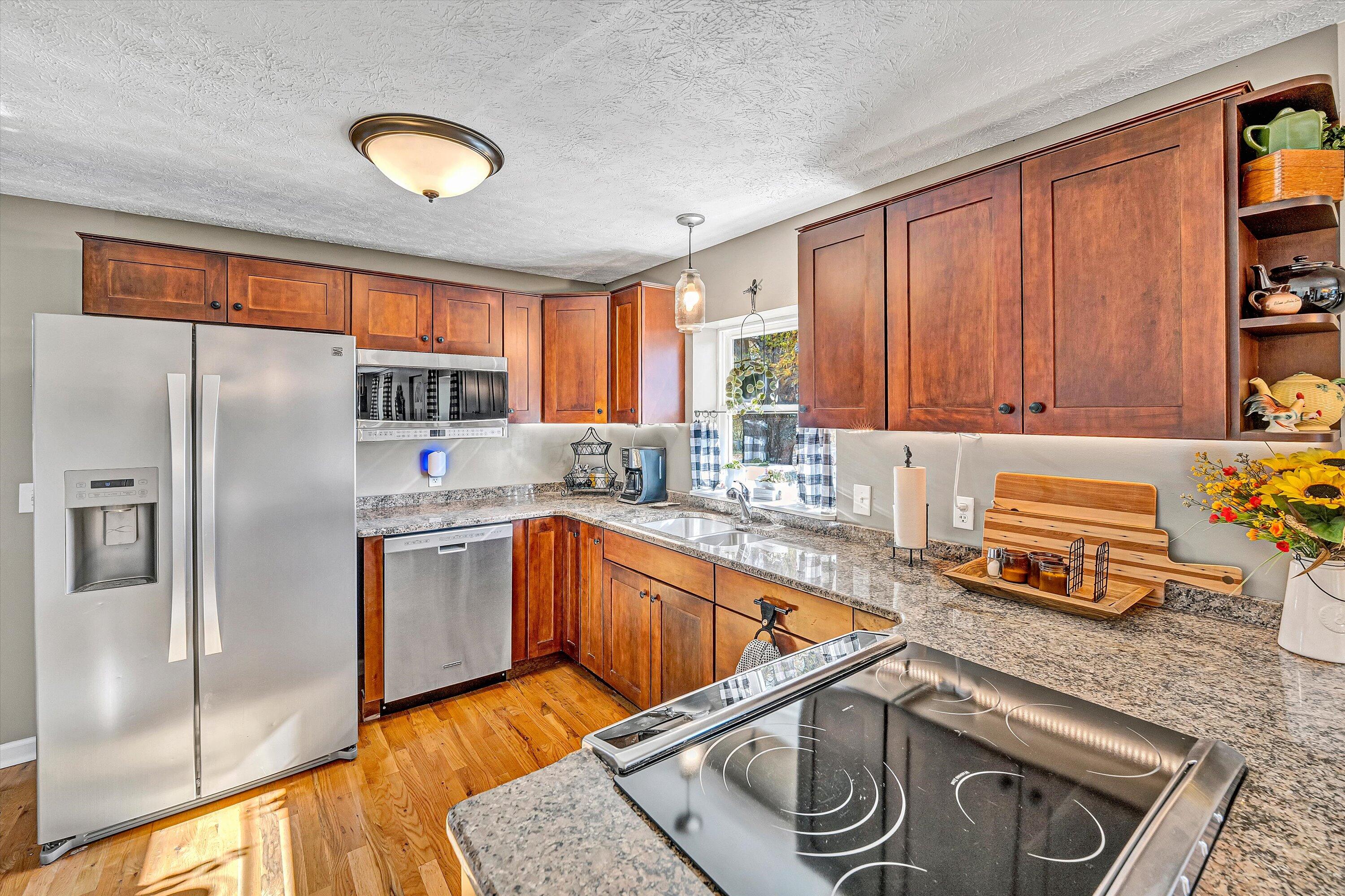 1620 Ayers Road Moneta, VA 24121 - Photo 16 of 63 a kitchen with stainless steel appliances granite countertop a sink stove and refrigerator