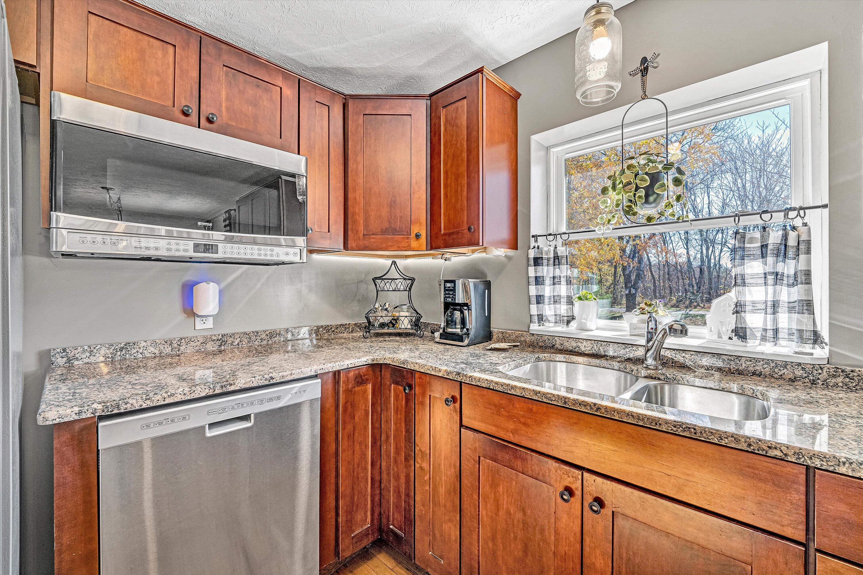 1620 Ayers Road Moneta, VA 24121 - Photo 19 of 63 a kitchen with stainless steel appliances granite countertop a sink a microwave cabinets and a window