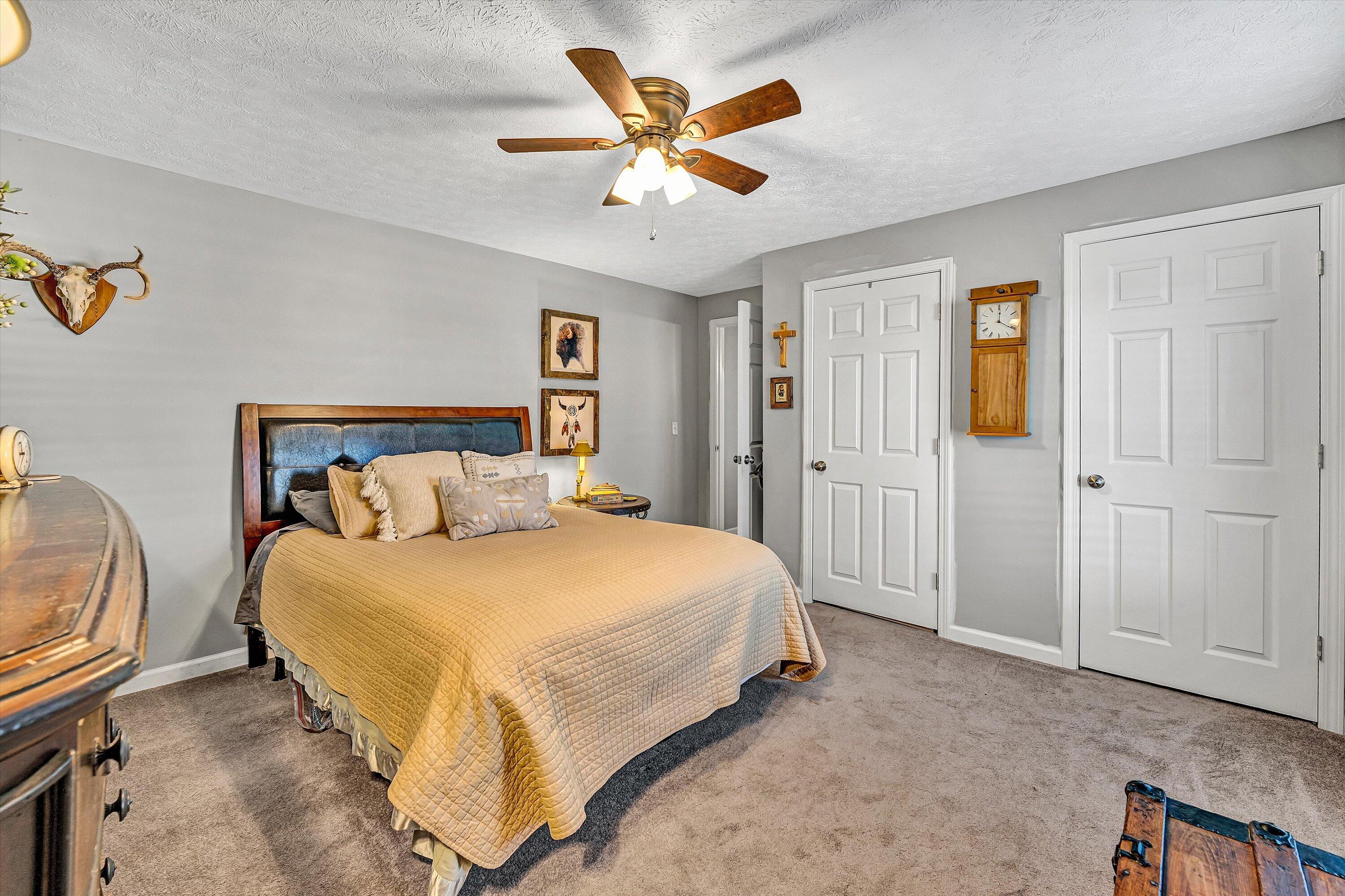 1620 Ayers Road Moneta, VA 24121 - Photo 32 of 63 a spacious bedroom with a bed and a chandelier