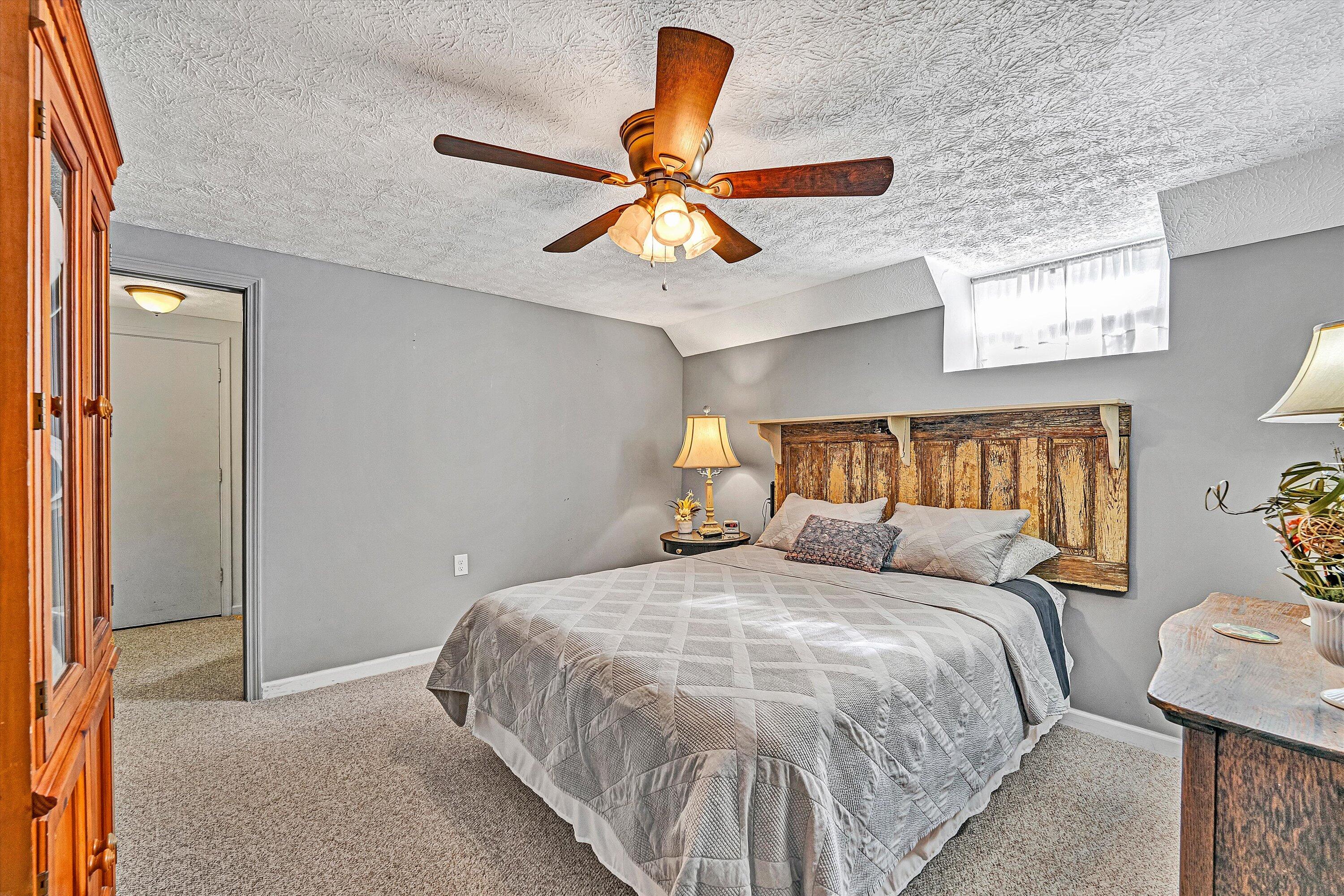 1620 Ayers Road Moneta, VA 24121 - Photo 46 of 63 a bedroom with a bed and a chandelier