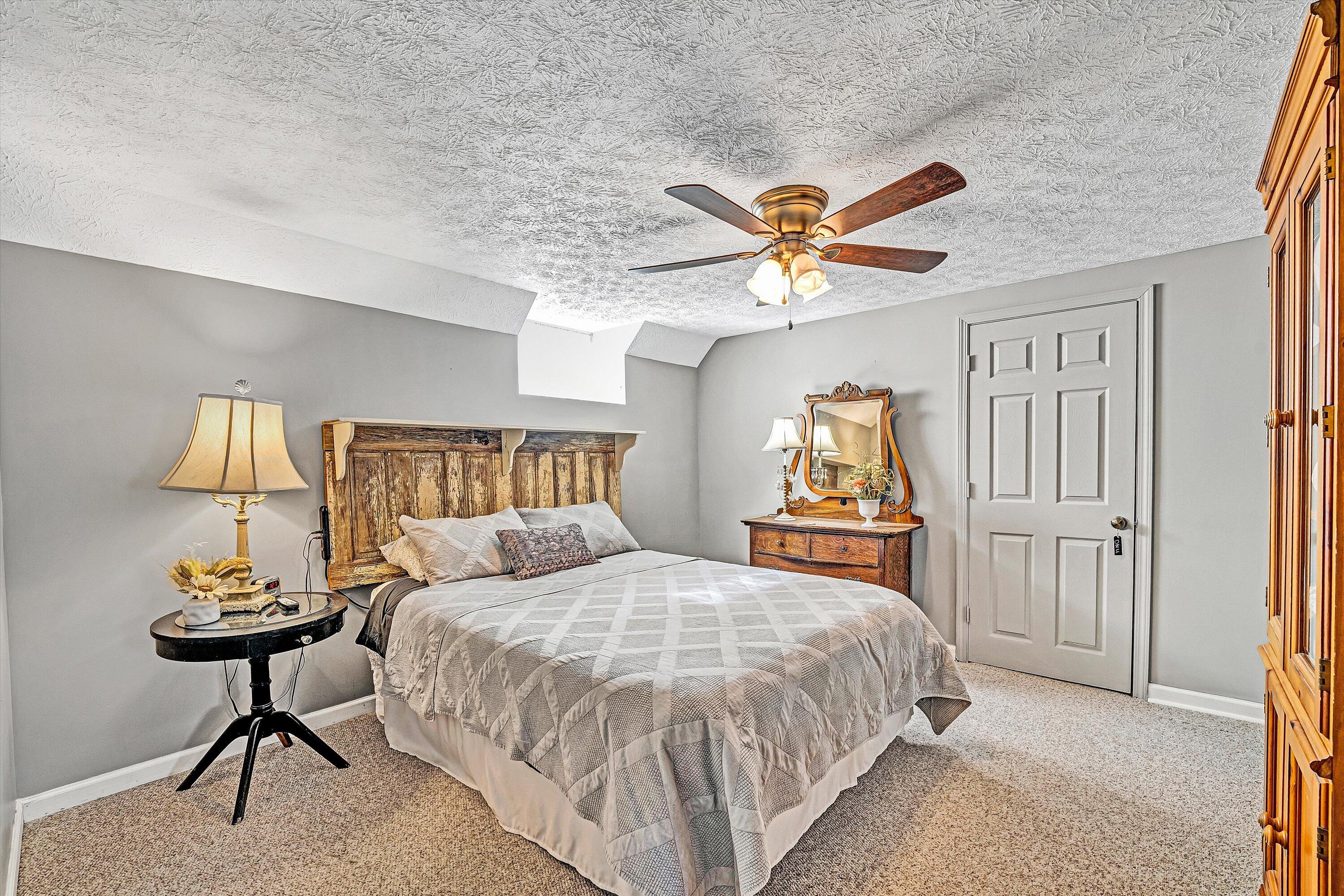 1620 Ayers Road Moneta, VA 24121 - Photo 47 of 63 a bedroom with a bed and a chandelier