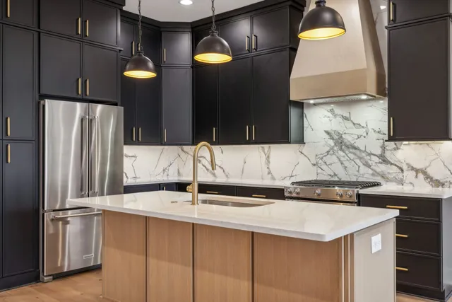 a kitchen that has a sink and a stove in it