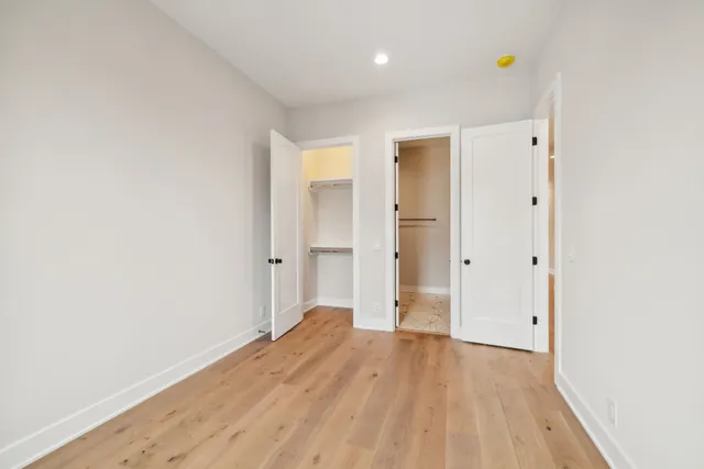 a view of a hallway with a wooden cabinets