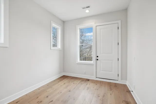 a view of a hallway with wooden floor