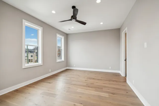 a bathroom with a granite countertop double vanity sink and a mirror