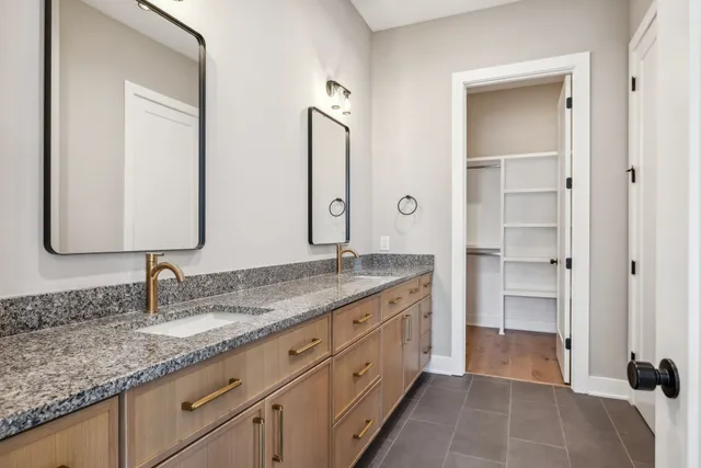 a bathroom with double sink and a mirror
