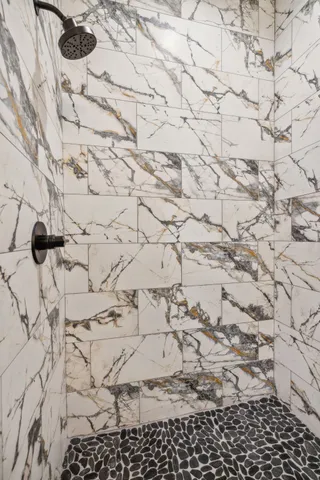 a bathroom with a sink a mirror and shower