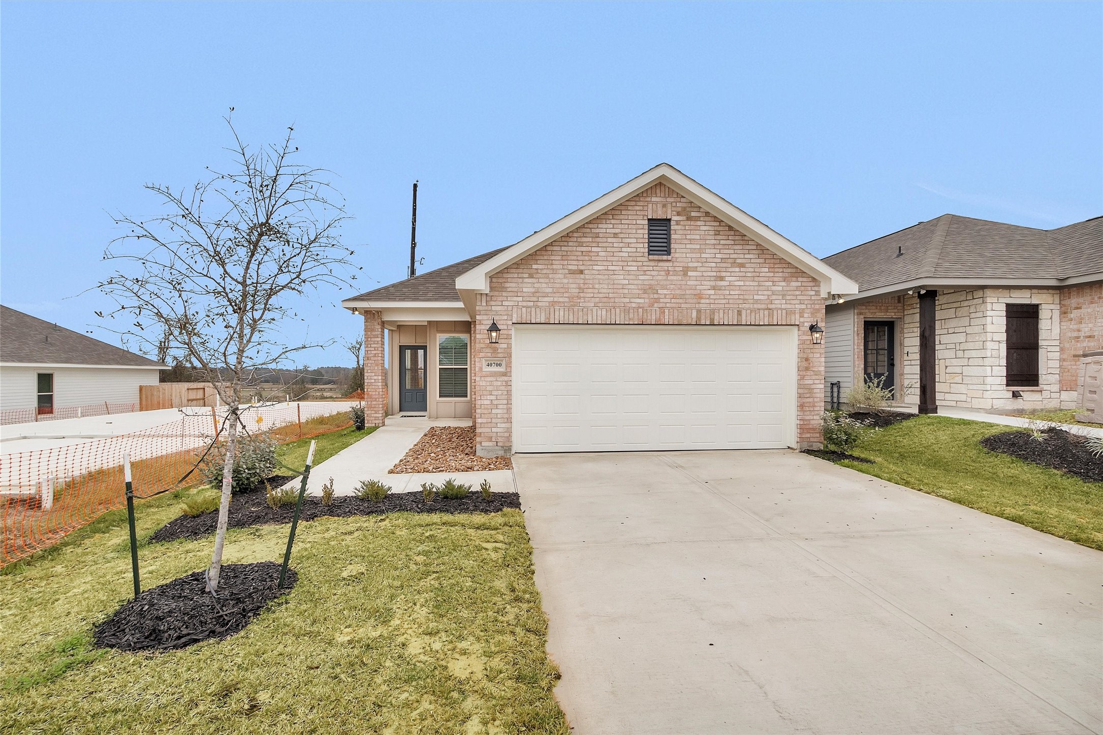 40700 Pessi Road Magnolia, TX 77354 - Photo 1 of 29 a front view of a house with garden