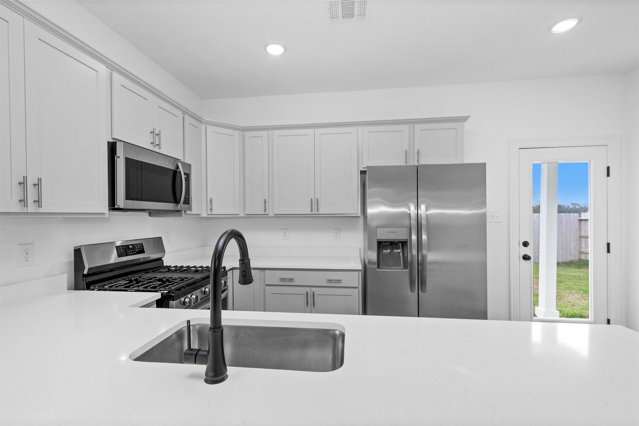 40700 Pessi Road Magnolia, TX 77354 - Photo 11 of 29 a kitchen with a refrigerator and a sink
