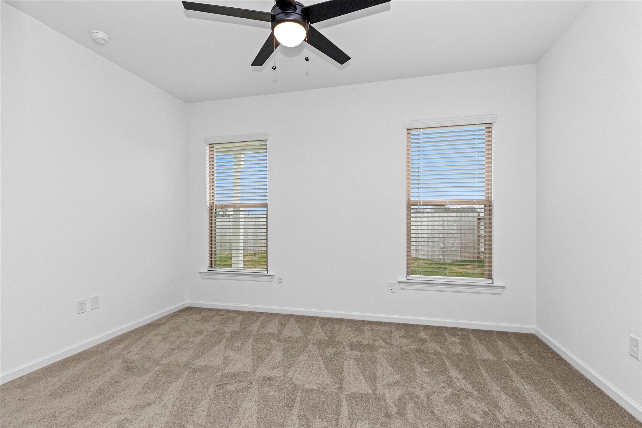 40700 Pessi Road Magnolia, TX 77354 - Photo 21 of 29 an empty room with windows and fan