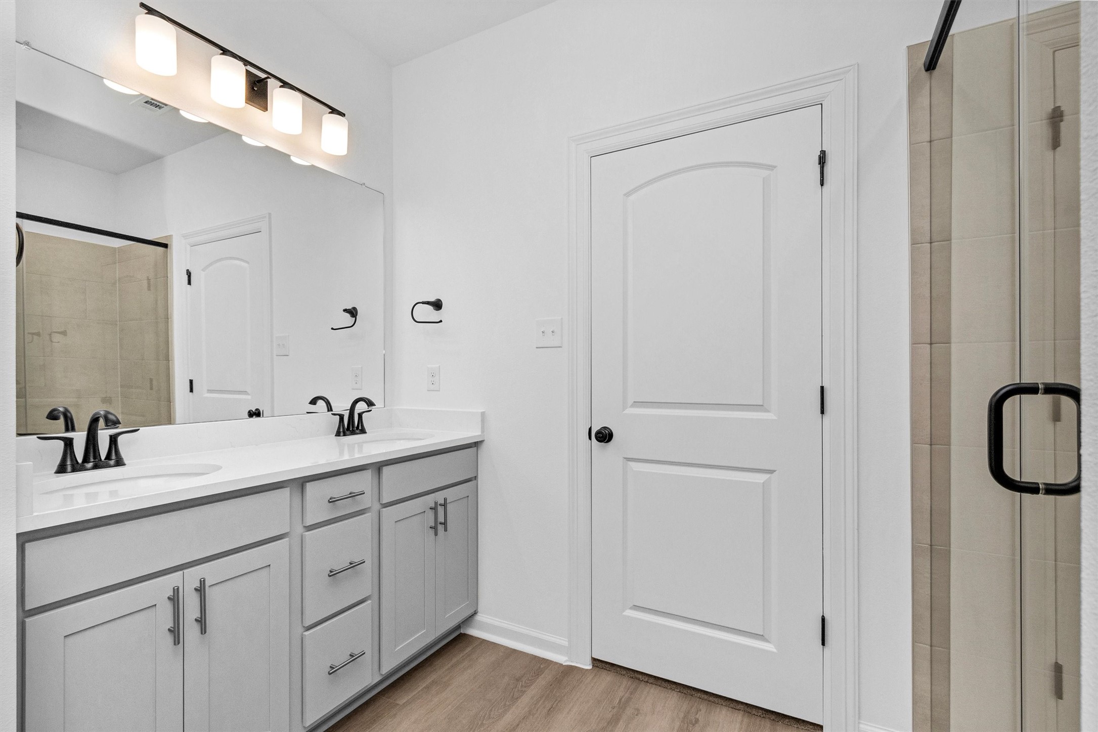 40700 Pessi Road Magnolia, TX 77354 - Photo 24 of 29 a bathroom with a double vanity sink and mirror