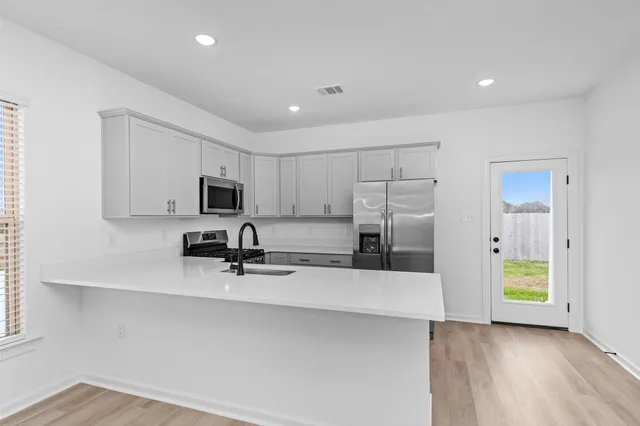 a view of a kitchen with microwave and cabinets