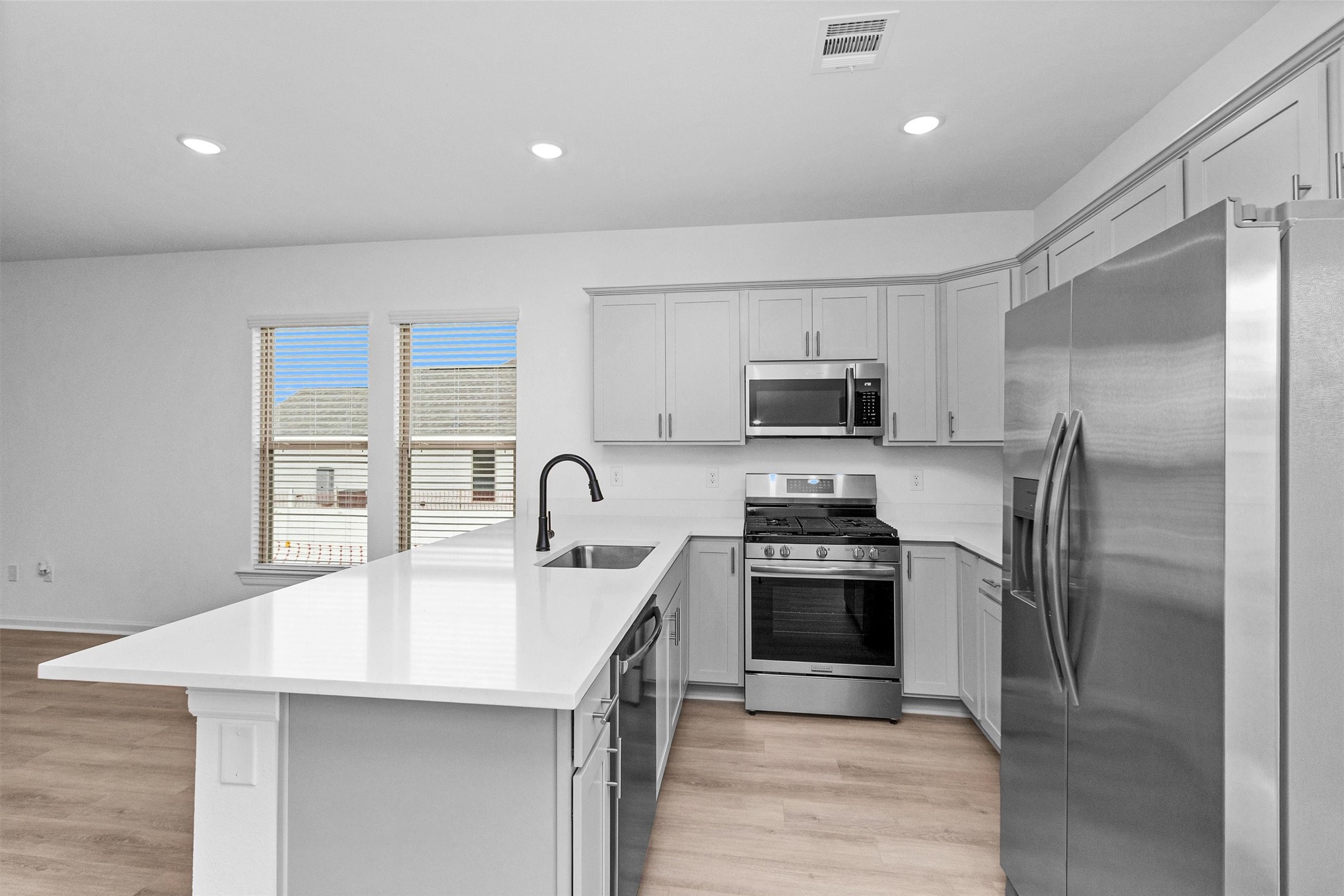 40700 Pessi Road Magnolia, TX 77354 - Photo 9 of 29 a kitchen with a sink stainless steel appliances and cabinets