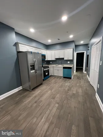 a kitchen with refrigerator and microwave