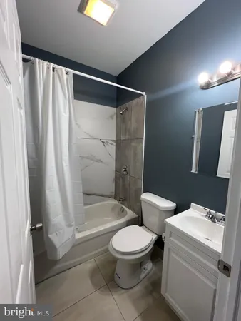a white toilet sitting next to a bathroom sink